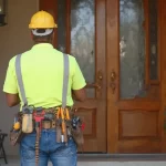 Skilled Dubai carpenter repairing and installing a main entrance door in a villa